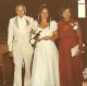 Joanie and parents at wedding
